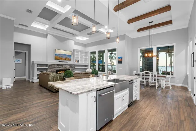 a kitchen with cabinets wooden floor and stainless steel appliances