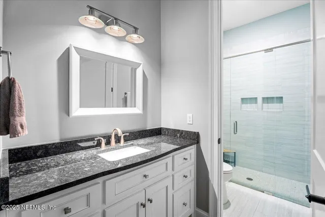 a view of a workspace with furniture and wooden floor