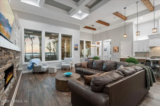 an aerial view of a house with a yard and a large tree