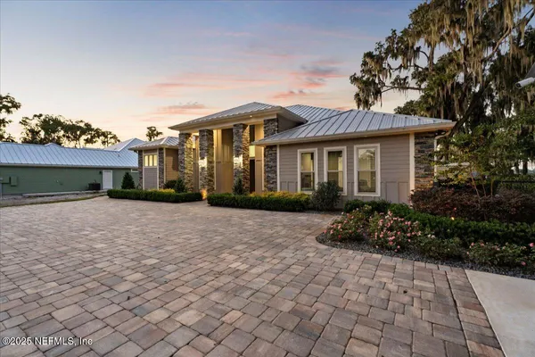 a front view of a house with a yard and a garage