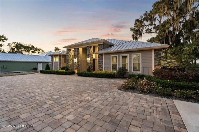 a front view of a house with a yard and a garage
