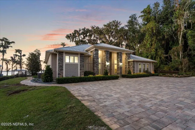 a front view of a house with a garden