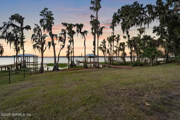 a view of a house with a yard and sitting area