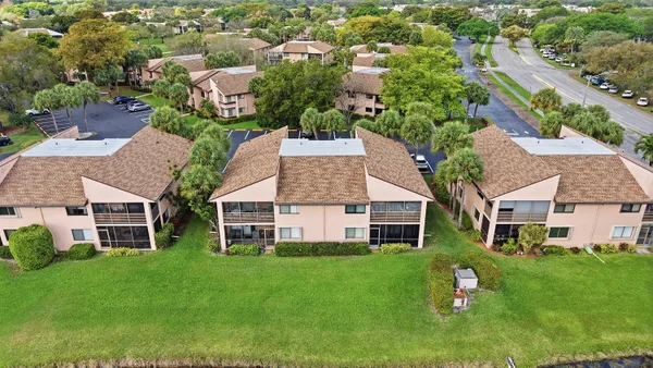 an aerial view of residential houses with outdoor space