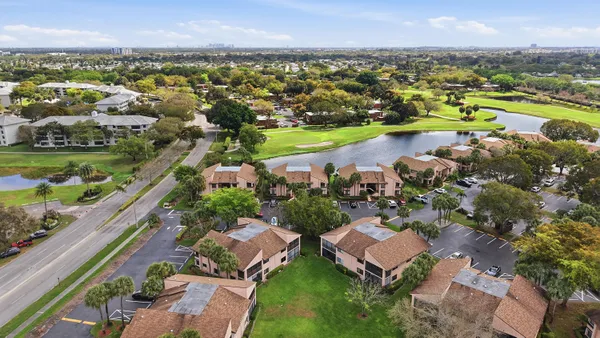 an aerial view of residential building and lake