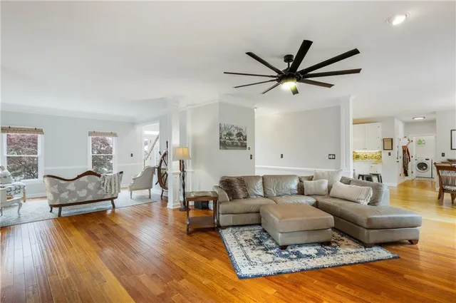 a living room with furniture and a wooden floor