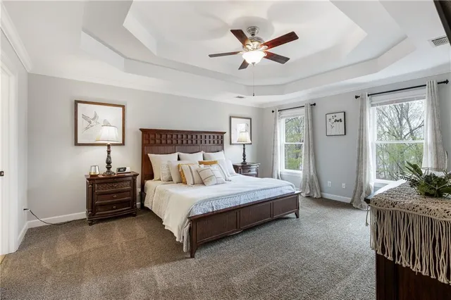 a spacious bedroom with a bed and a large window