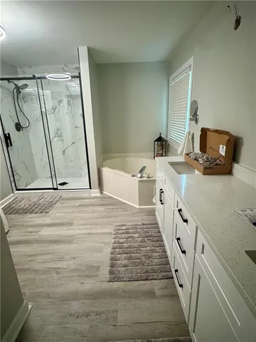 a bathroom with a sink a mirror and shower