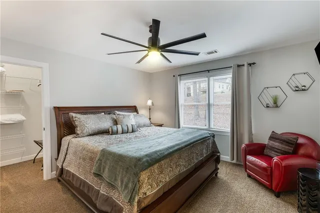 a bedroom with a large bed and a flat screen tv