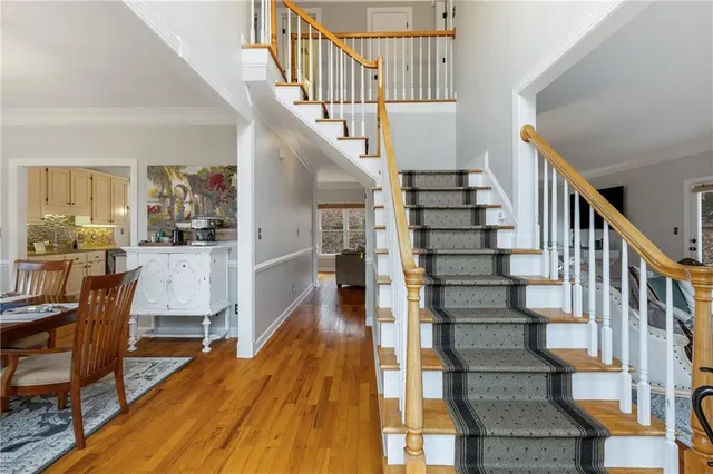a view of entryway and hall with wooden floor