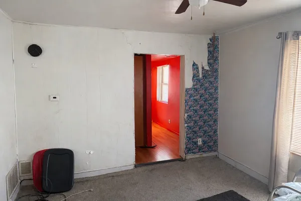 a view of an empty room with windows