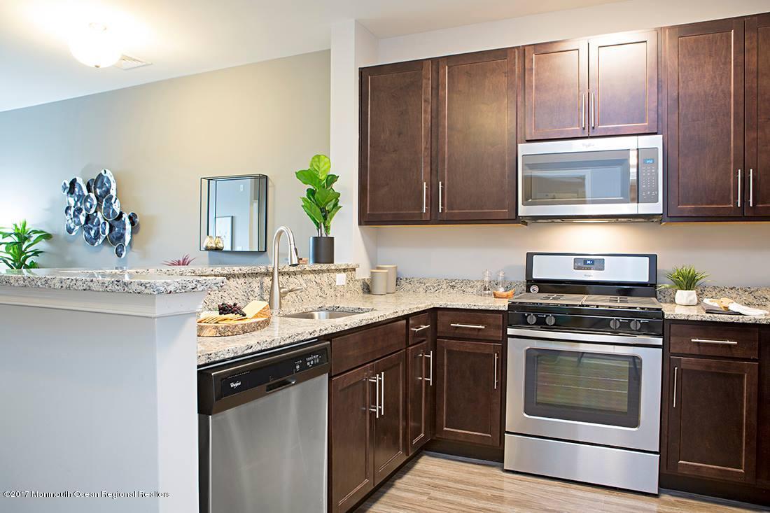 249 Broad Street, Unit 428 Matawan, NJ 07747 - Photo 13 of 27 a kitchen with a sink stove and microwave