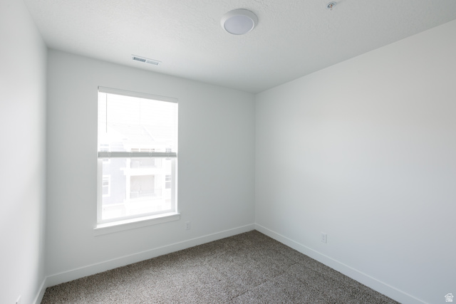 4653 South Alder Drive, Unit H303 Mapleton, UT 84664 - Photo 8 of 15 Carpeted spare room featuring baseboards