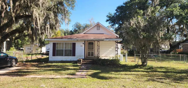 a front view of a house with a yard table and chairs