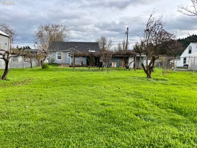 196 Northeast Flagg Street Roseburg, OR 97470 - Photo 6 of 27 a view of a big house with a big yard and large trees