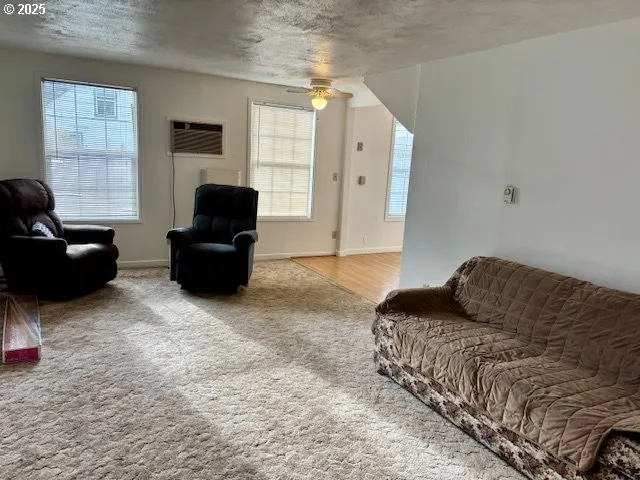 a bedroom with bed couch and window