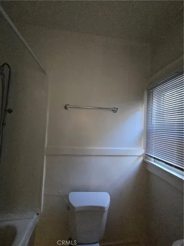 a bathroom with a wooden floor and a window