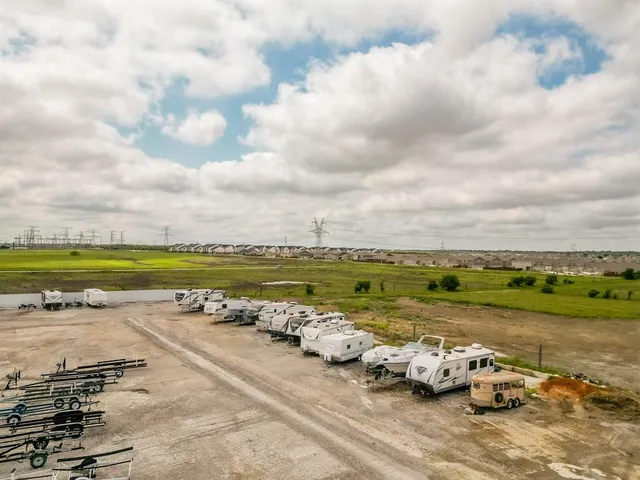 an outdoor space with lots of car parked