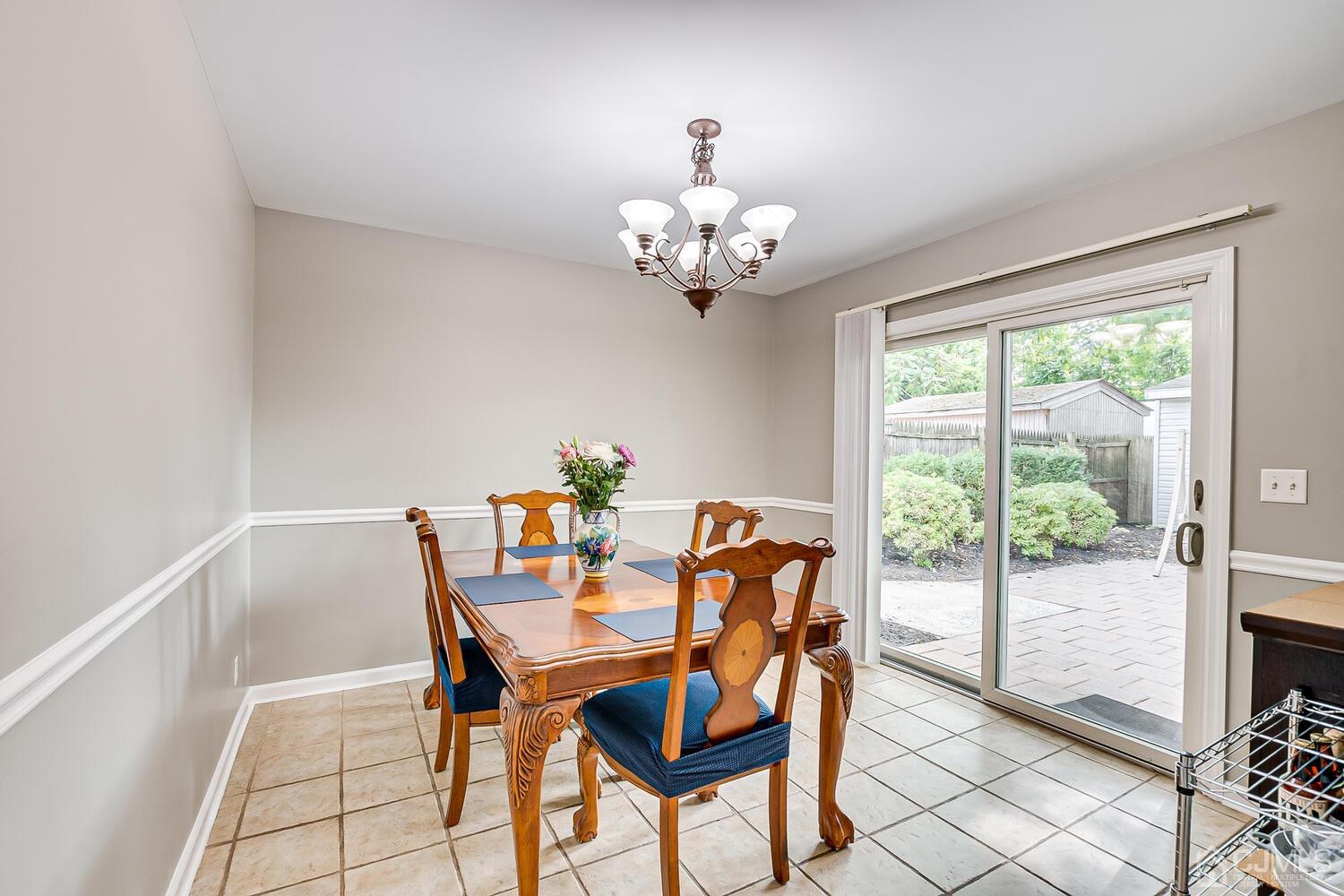 6 Stiles Road Edison, NJ 08817 - Photo 14 of 28 a view of a dining room with furniture a chandelier and wooden floor