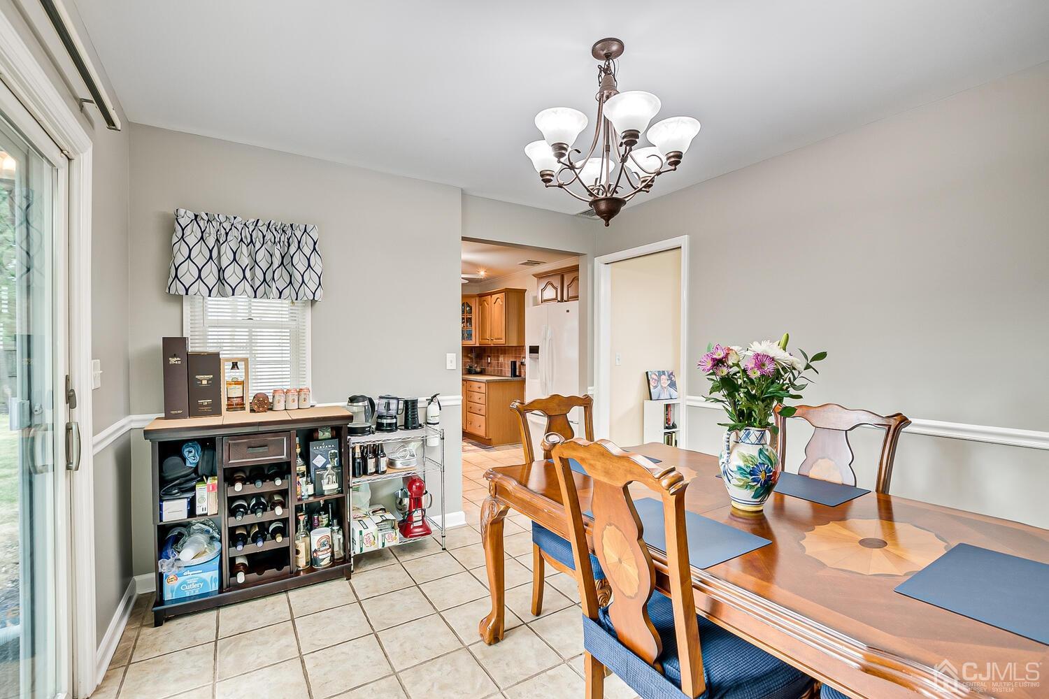 6 Stiles Road Edison, NJ 08817 - Photo 15 of 28 a view of a dining room with furniture wooden floor and chandelier