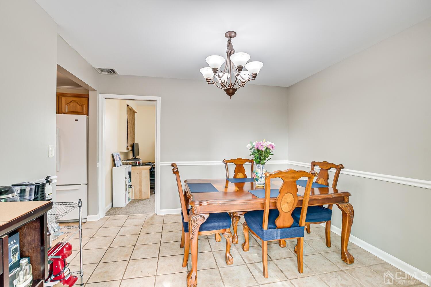 6 Stiles Road Edison, NJ 08817 - Photo 16 of 28 a view of a dining room with furniture and chandelier