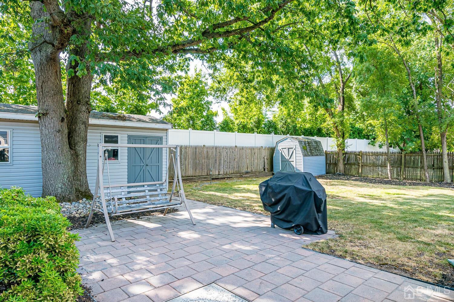 6 Stiles Road Edison, NJ 08817 - Photo 25 of 28 a backyard of a house with barbeque oven and trees