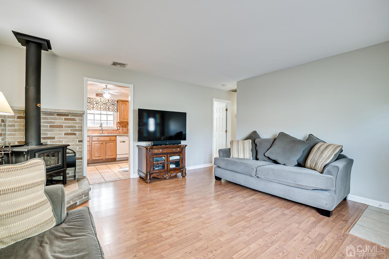 6 Stiles Road Edison, NJ 08817 - Photo 8 of 28 a living room with furniture and a flat screen tv