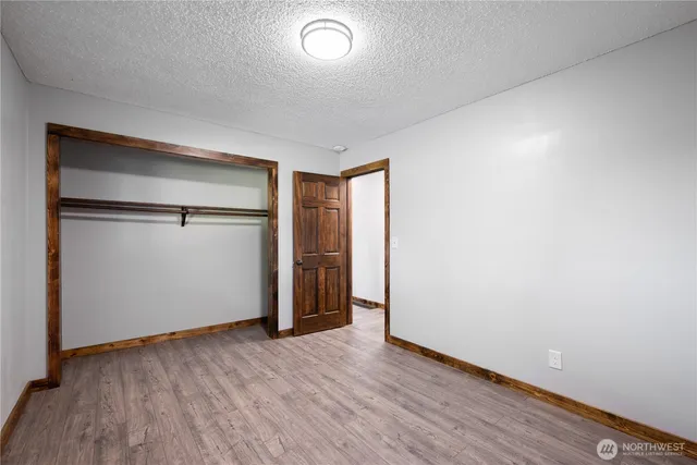 a view of a room with wooden floor