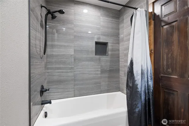 a bathroom with a bathtub and a shower