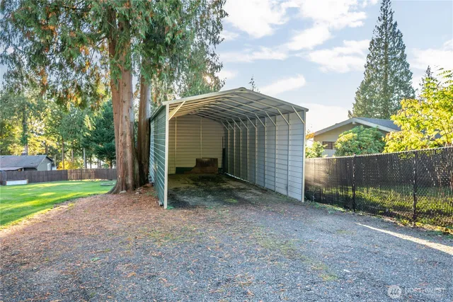 a view of a backyard with a garden and deck