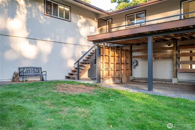 a view of a house with a yard and porch