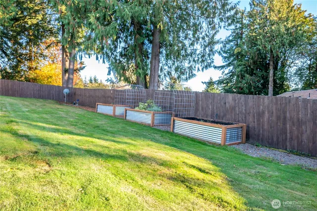 a view of a house with a big yard and palm trees