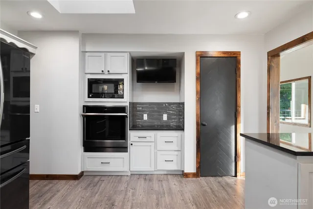 a kitchen with stainless steel appliances a refrigerator and a stove top oven