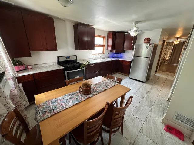 a kitchen with stainless steel appliances granite countertop a stove refrigerator and microwave