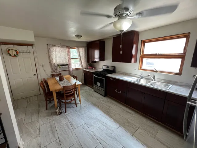 a kitchen with a sink stove and refrigerator