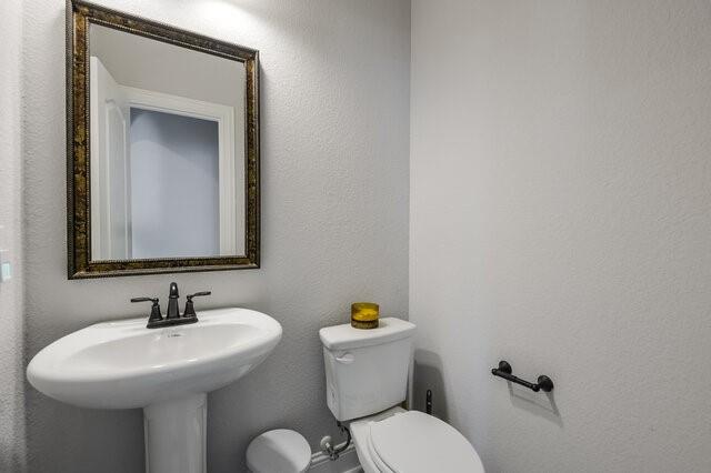 807 Imperial Way Mansfield, TX 76063 - Photo 16 of 39 a bathroom with a sink mirror and toilet