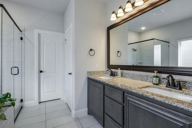 807 Imperial Way Mansfield, TX 76063 - Photo 19 of 39 a bathroom with a granite countertop sink a mirror and a shower