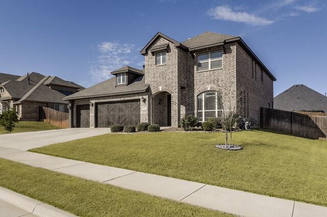 807 Imperial Way Mansfield, TX 76063 - Photo 3 of 39 a front view of a house with a yard