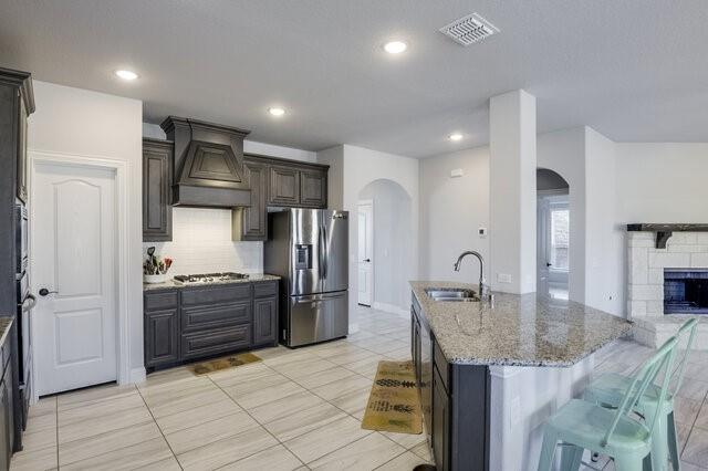 807 Imperial Way Mansfield, TX 76063 - Photo 7 of 39 a kitchen with stainless steel appliances granite countertop a refrigerator and a stove top oven