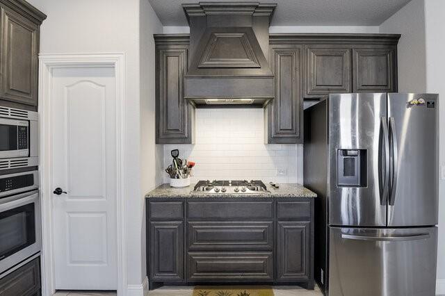 807 Imperial Way Mansfield, TX 76063 - Photo 9 of 39 a kitchen with a refrigerator and cabinets