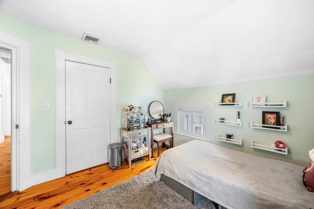 13 State Street Peabody, MA 01960 - Photo 28 of 42 a bed room with a bed and a wooden floor