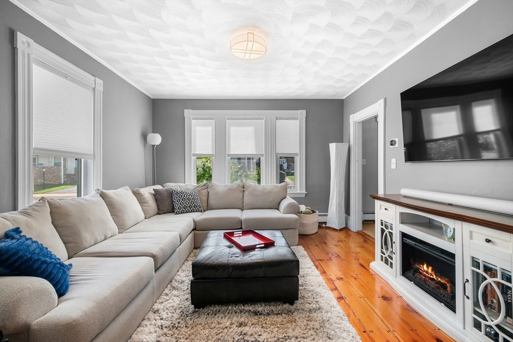 13 State Street Peabody, MA 01960 - Photo 4 of 42 a living room with furniture and a fireplace