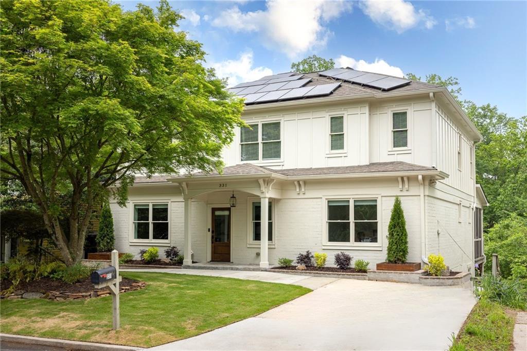 331 Gordon Avenue Northeast Atlanta, GA 30307 - Photo 1 of 1 a view of a white house with a yard and a large tree