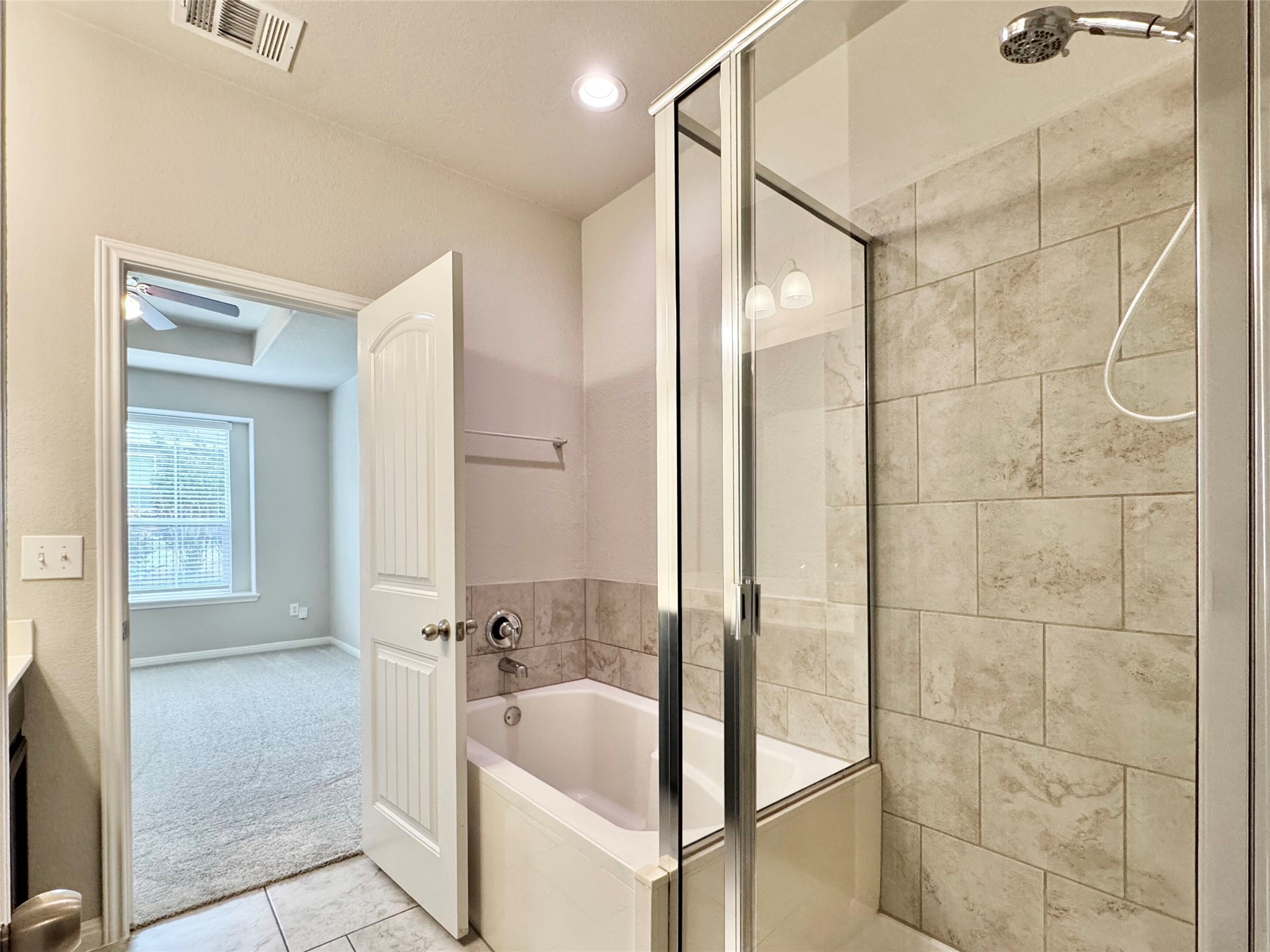 407 Rhetoric Way Pflugerville, TX 78660 - Photo 30 of 38 a bathroom with a bathtub and shower