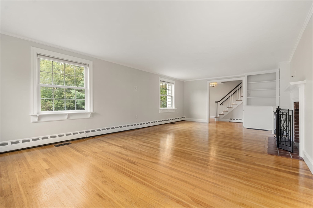 92 Abbot Street Andover, MA 01810 - Photo 14 of 35 a view of an empty room with wooden floor and a window
