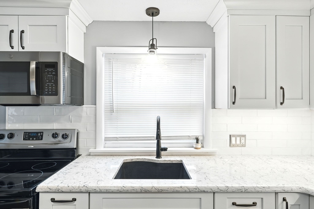 37 Gourley Road Springfield, MA 01129 - Photo 11 of 41 a kitchen with granite countertop a sink and a stove