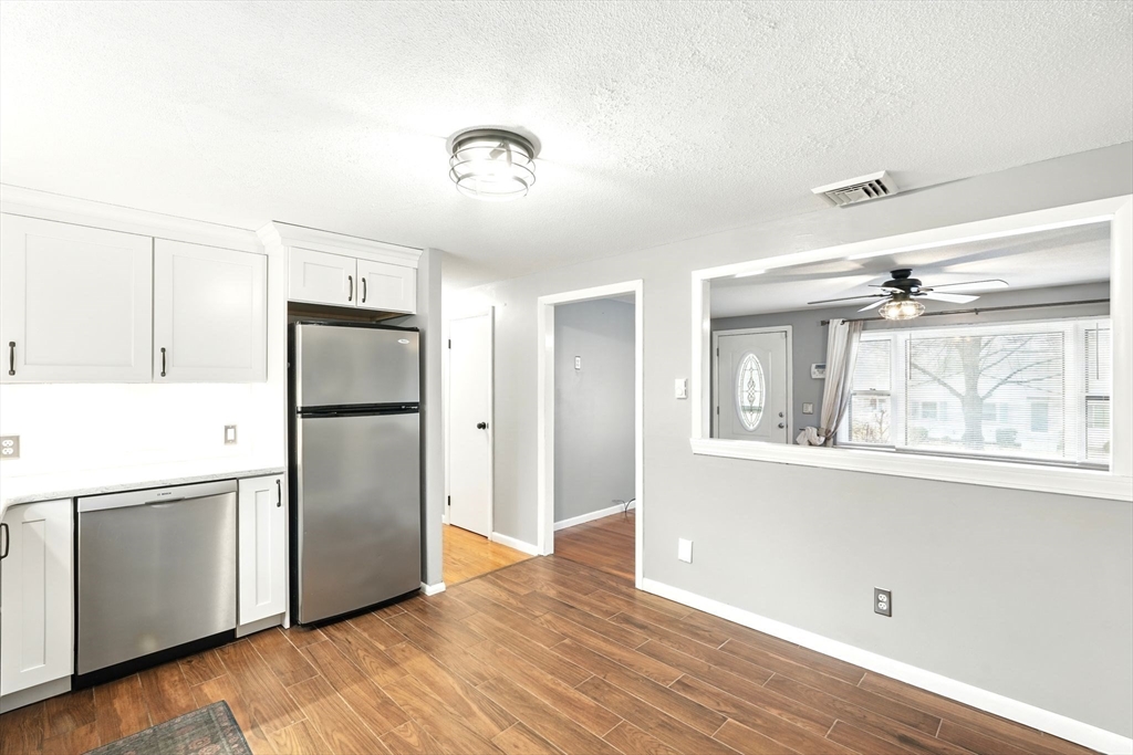 37 Gourley Road Springfield, MA 01129 - Photo 7 of 41 a view of a kitchen with wooden floor and a refrigerator