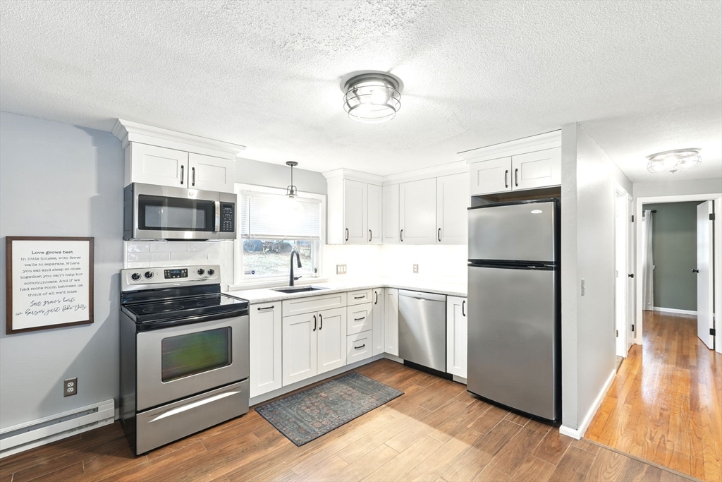 37 Gourley Road Springfield, MA 01129 - Photo 8 of 41 a kitchen with a refrigerator stove and microwave
