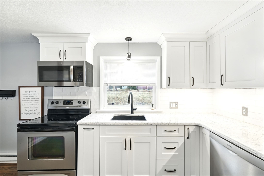 37 Gourley Road Springfield, MA 01129 - Photo 9 of 41 a kitchen with a sink stove and microwave