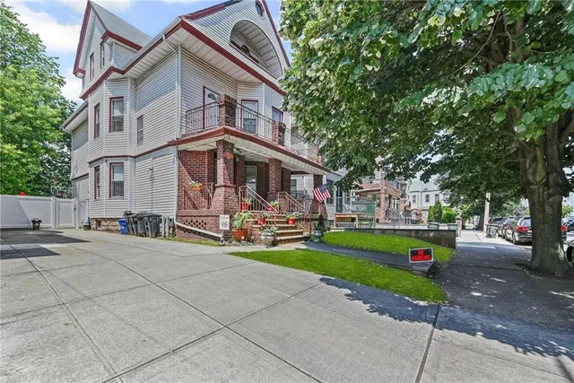 a view of a house with a yard and sitting area